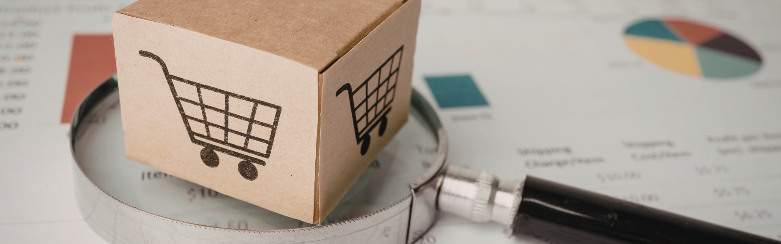 Analyzing e commerce growth with a magnifying glass and product box