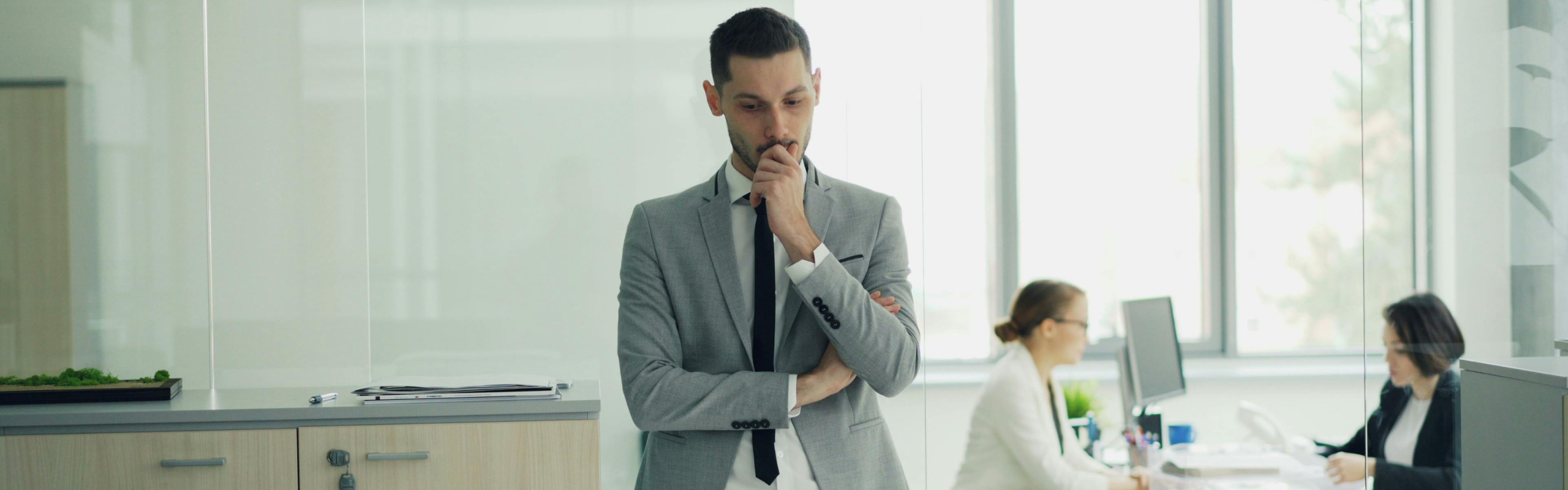 Businessman in Office Pondering Decision