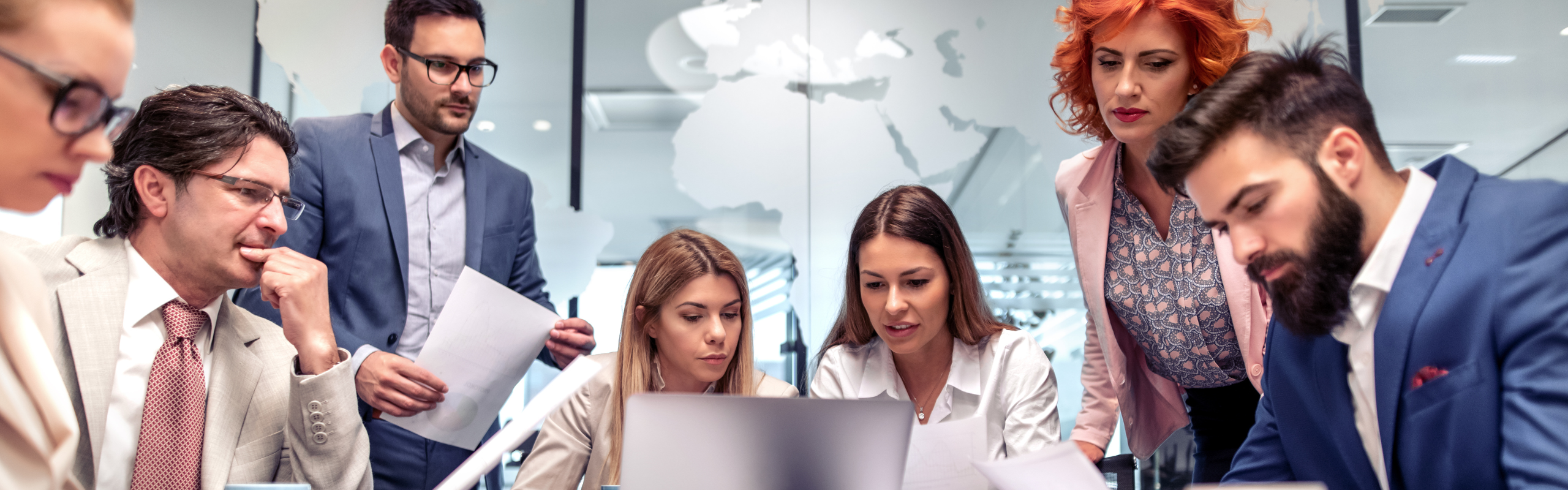 Group of business people working and communicating while sitting at the office desk