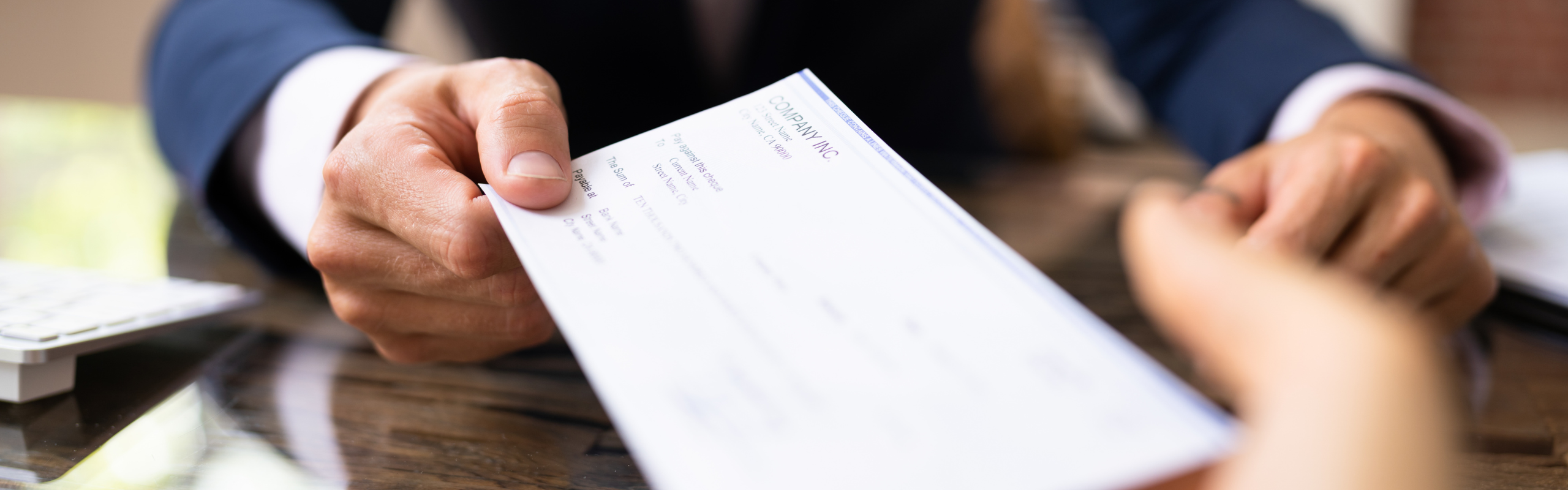 Hand Giving Payroll Compensation Paycheck