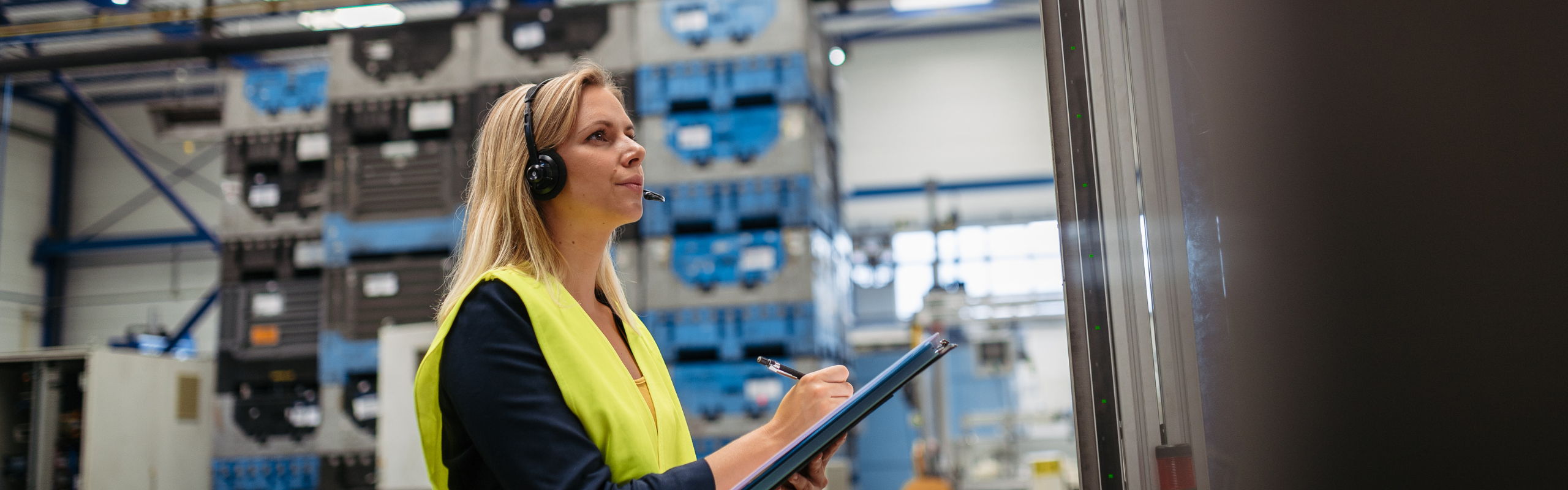 Female Factory Supervisor Checking Products in Industrial Production Hall.