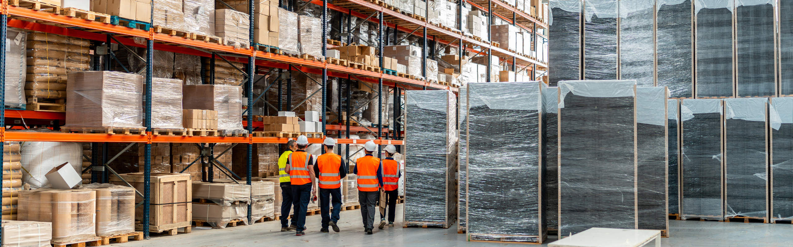 Warehouse workers inspecting logistics inventory management system