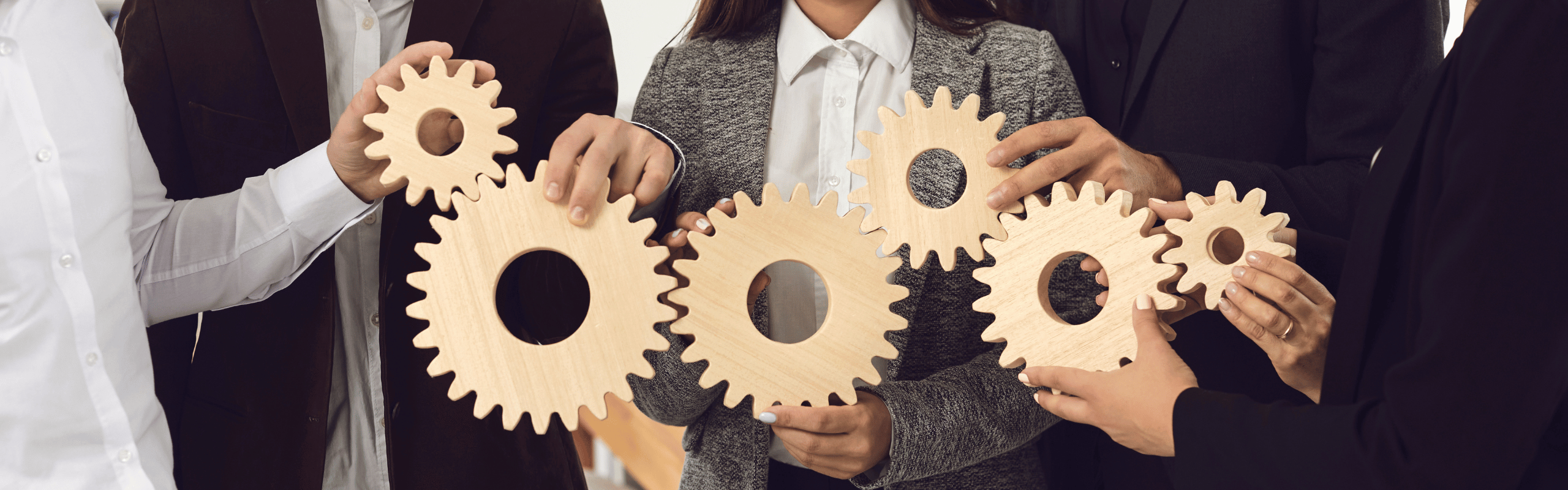 Company Employees Joining Gearwheels as Metaphor for Effective Business Management and Teamwork