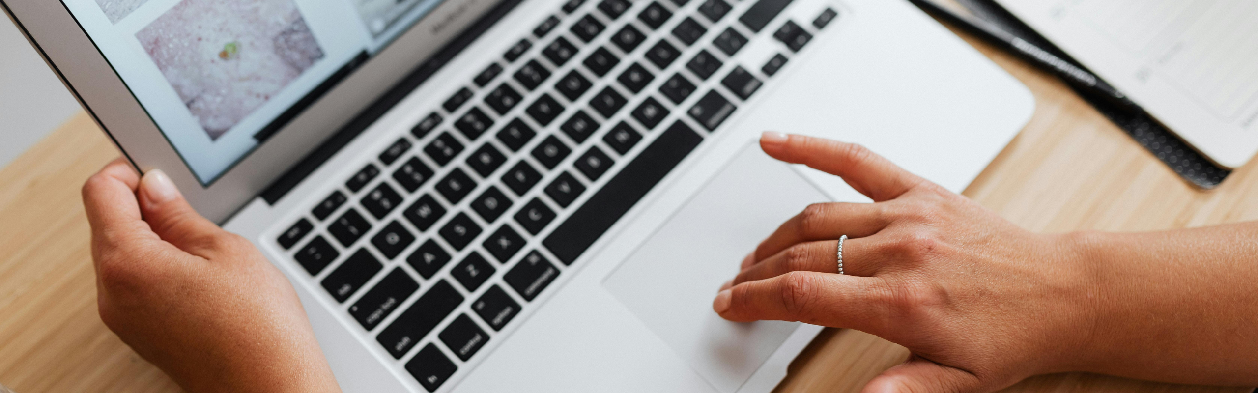 Person Using a Laptop to Browse the Internet