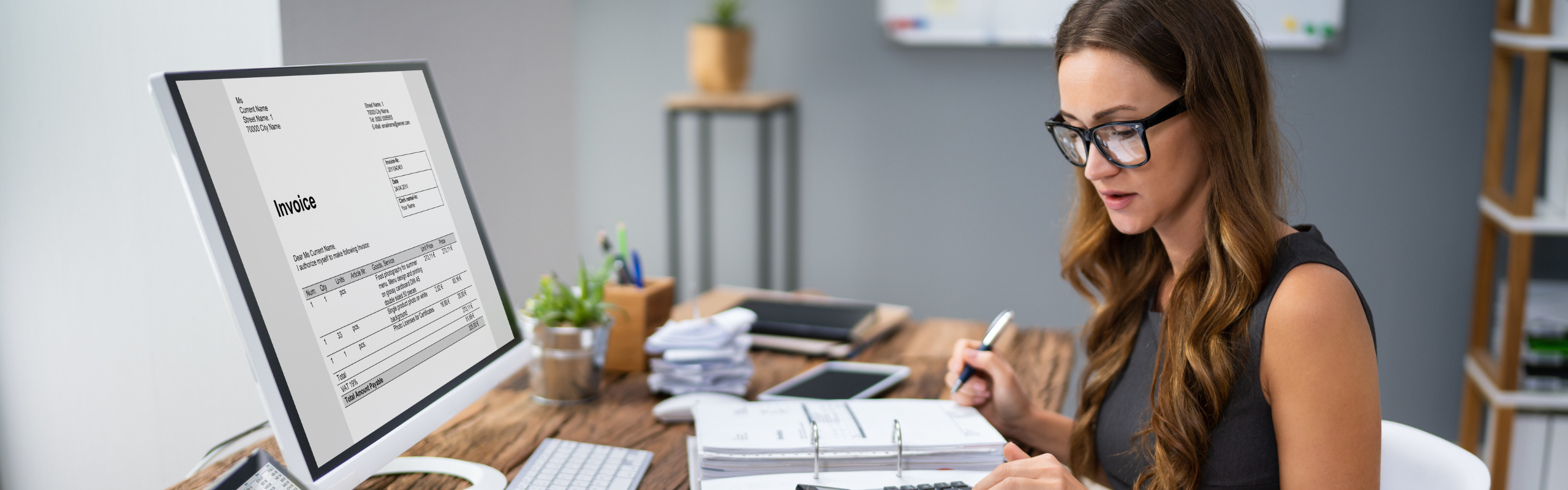 Accountant Calculating Tax At Desk