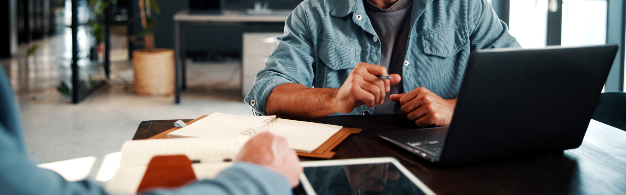 B2B, Meeting and People in Office with Laptop, Discussion and Collaboration for Digital Marketing. Man, Client and Talk in Creative Agency with Computer, Planning or Request for Advertising Campaign.