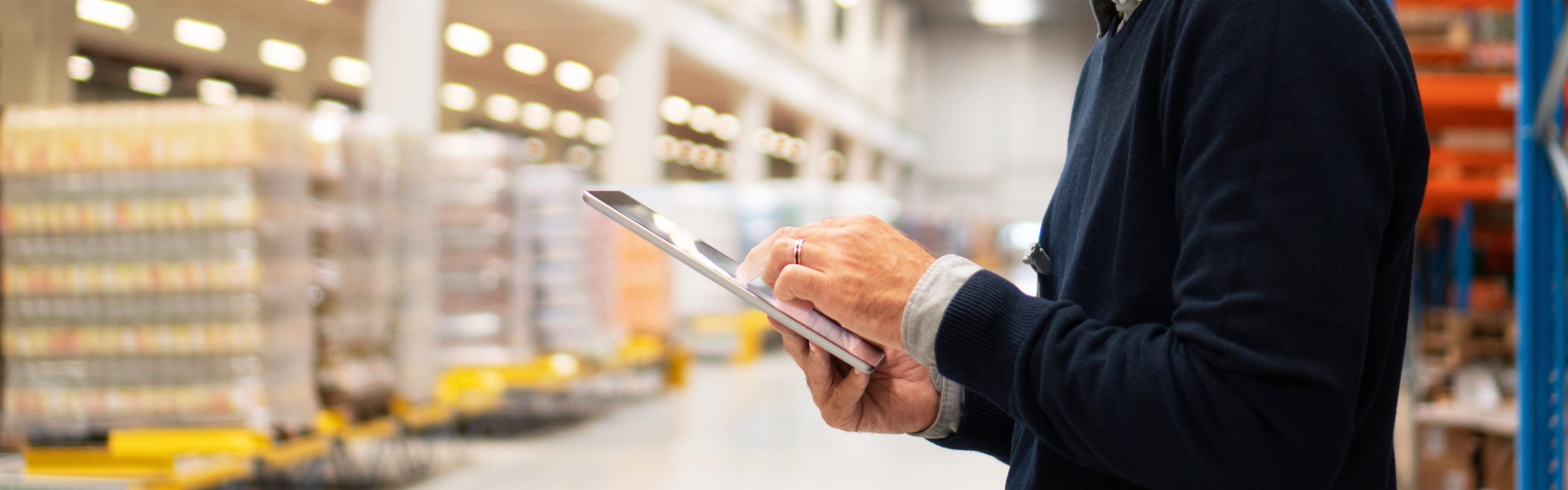 Manager holding digital tablet in warehouse