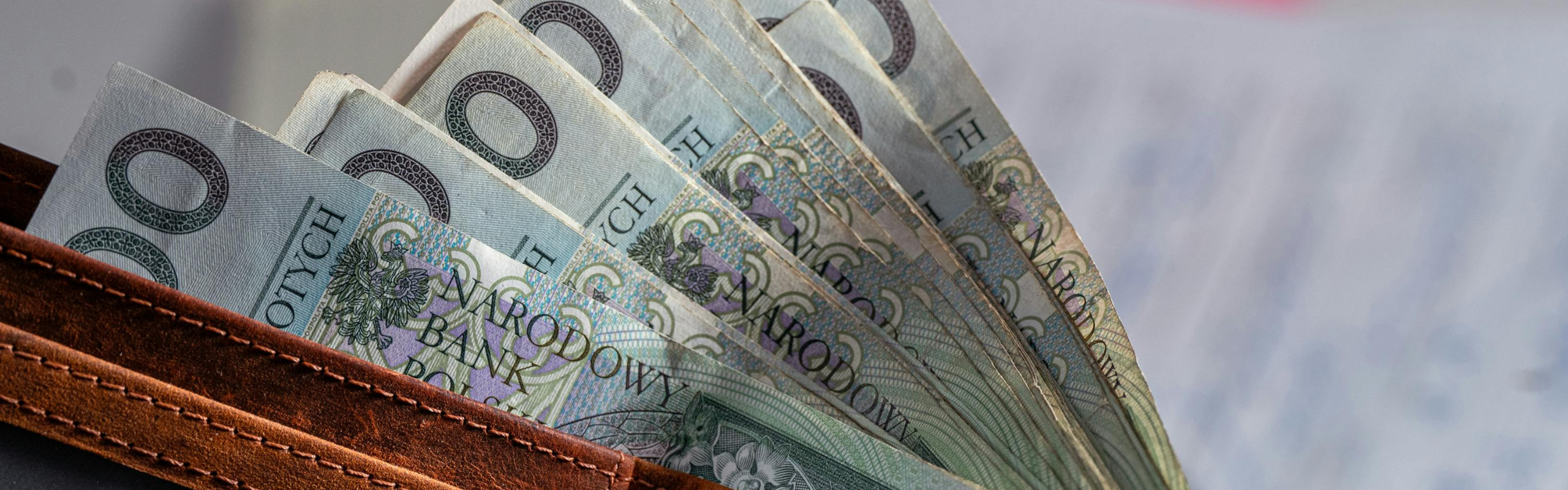 Wallet Filled with Polish Banknotes on Desk