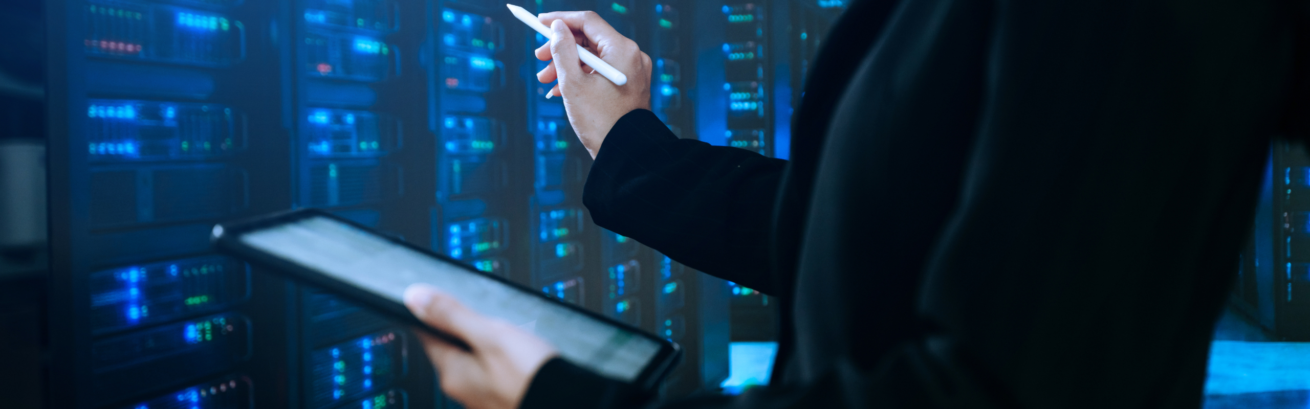 IT professional using tablet in data center server room, managin