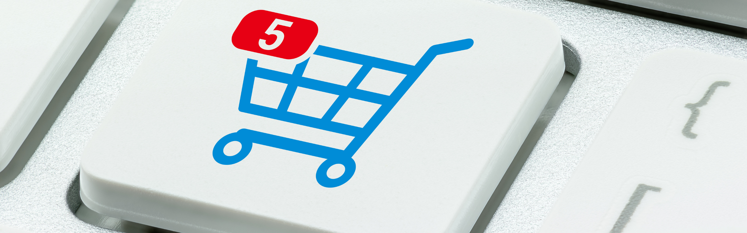 Online shopping / ecommerce and retail sale concept : Shopping cart with 5 items in a basket, a trolley symbol on a laptop keyboard, depicts customers order things from retailer sites using internet